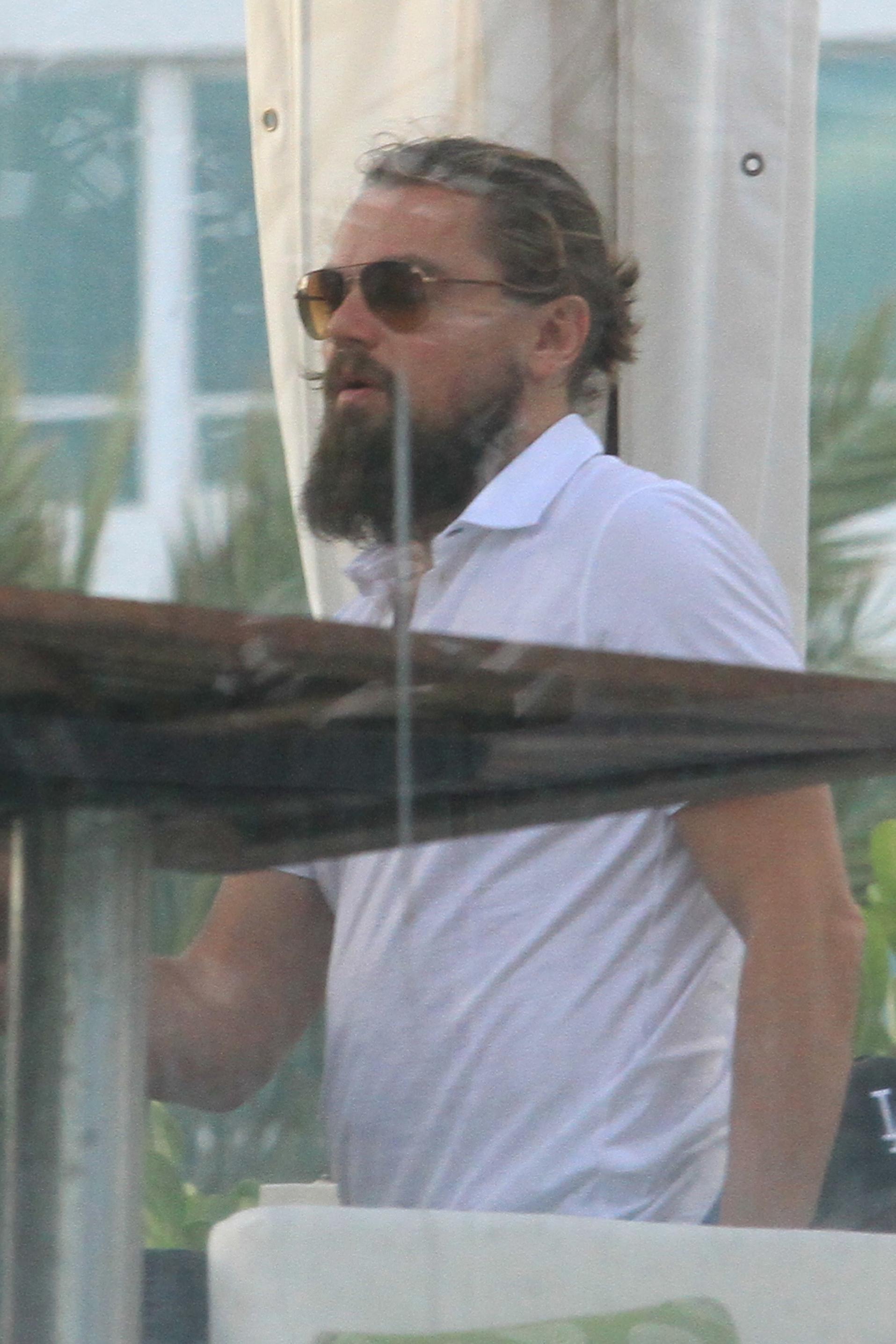 Leonardo DiCaprio seen with a beard and ponytail in Miami Beach