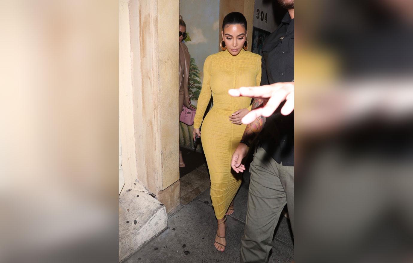 Kim Kardashian puts her curves on display in VERY tight yellow