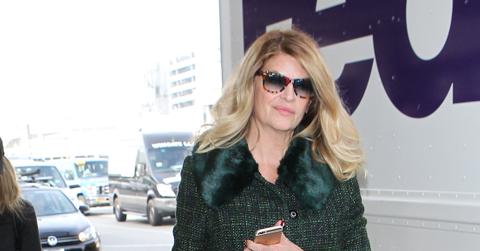 Kirstie Alley arrives for a flight with her dog by her side