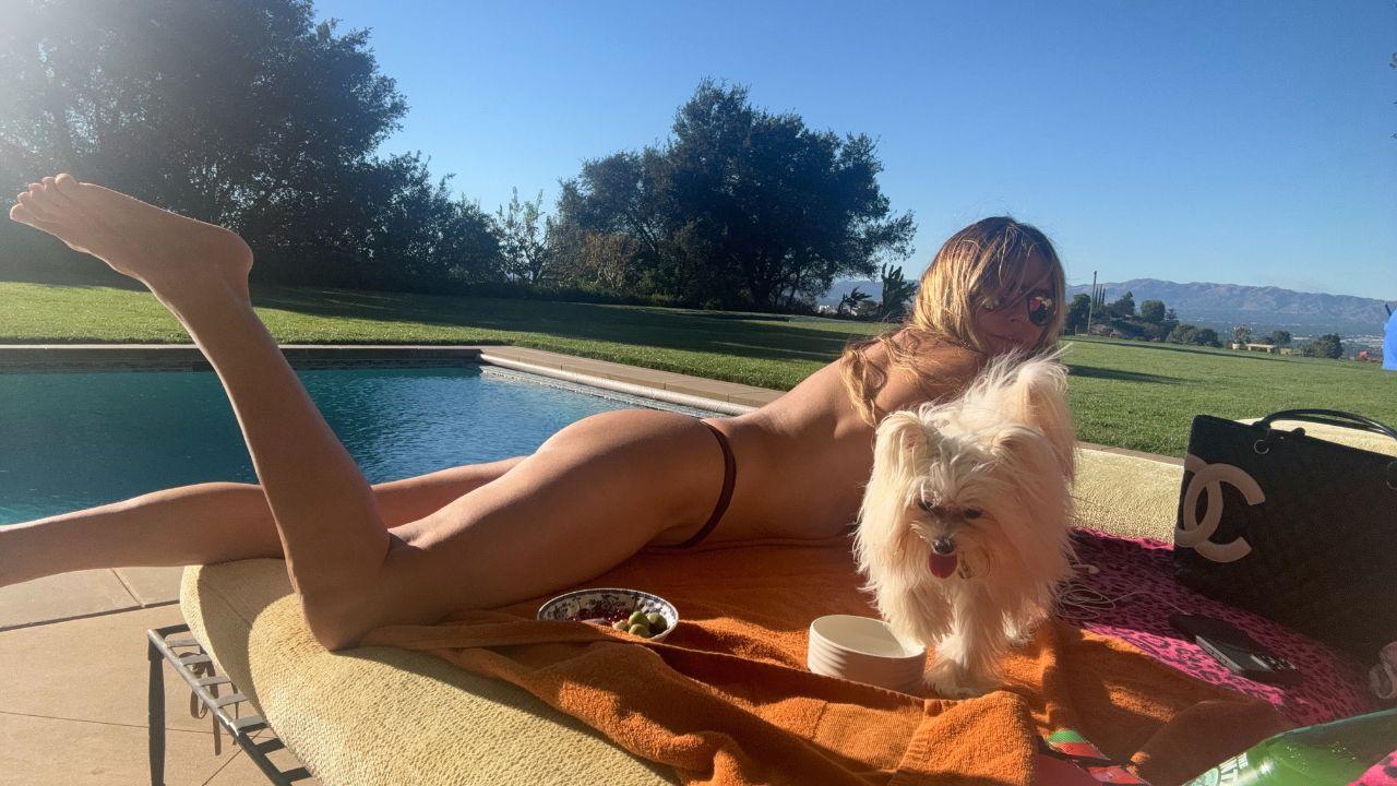 image of Heidi Klum shared a topless poolside photo on Instagram while enjoying the California sunshine.