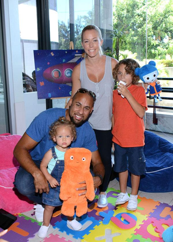 Kendra Wilkinson, Hank Baskett and their children Hank jr. and Alijah hug ABC Galaxy characters GIGGs and HUGG at the premier of BabyFirst TV show ABC Galaxy