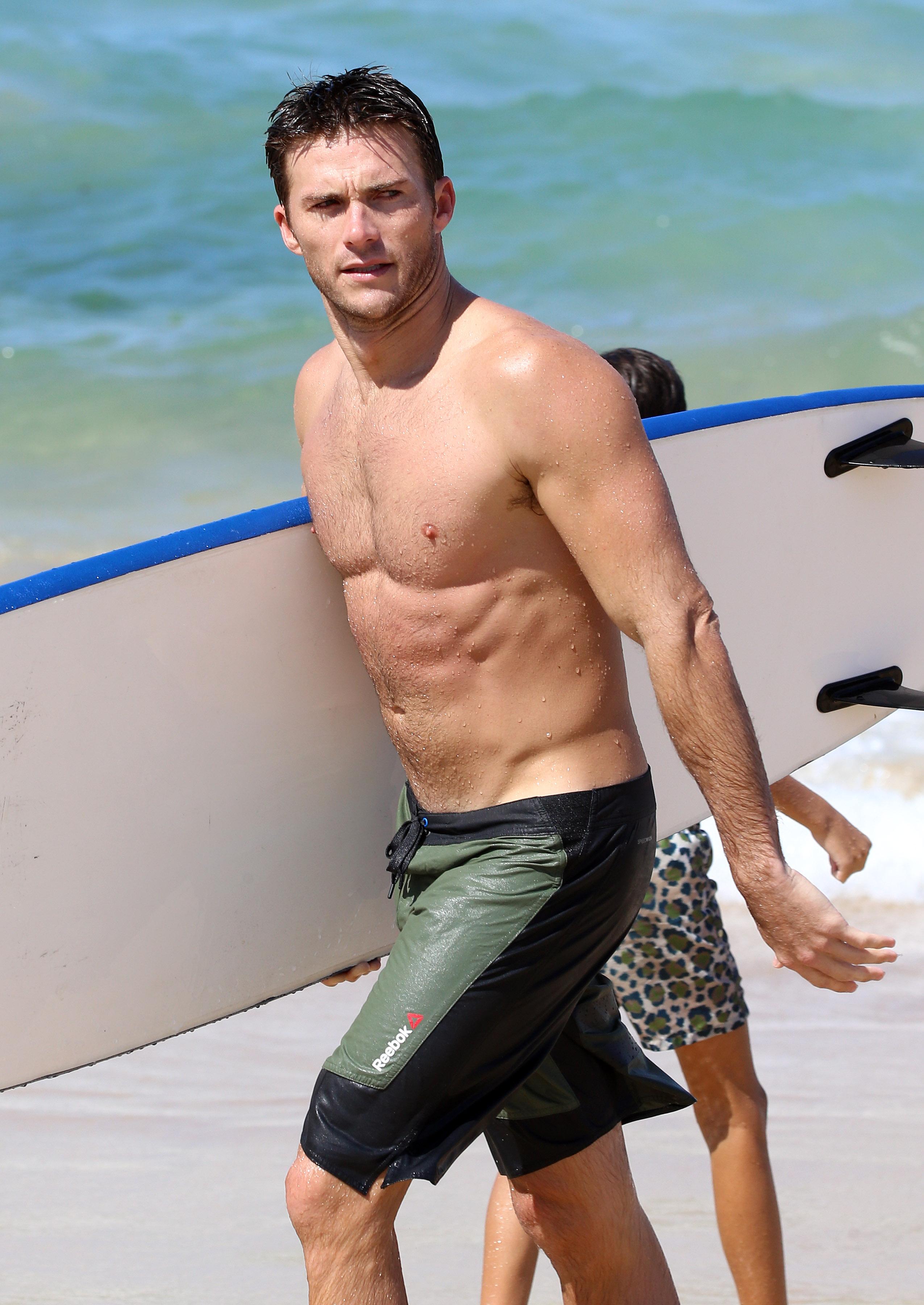 EXCLUSIVE: Scott Eastwood shows off his muscles while surfing at Bondi Beach.