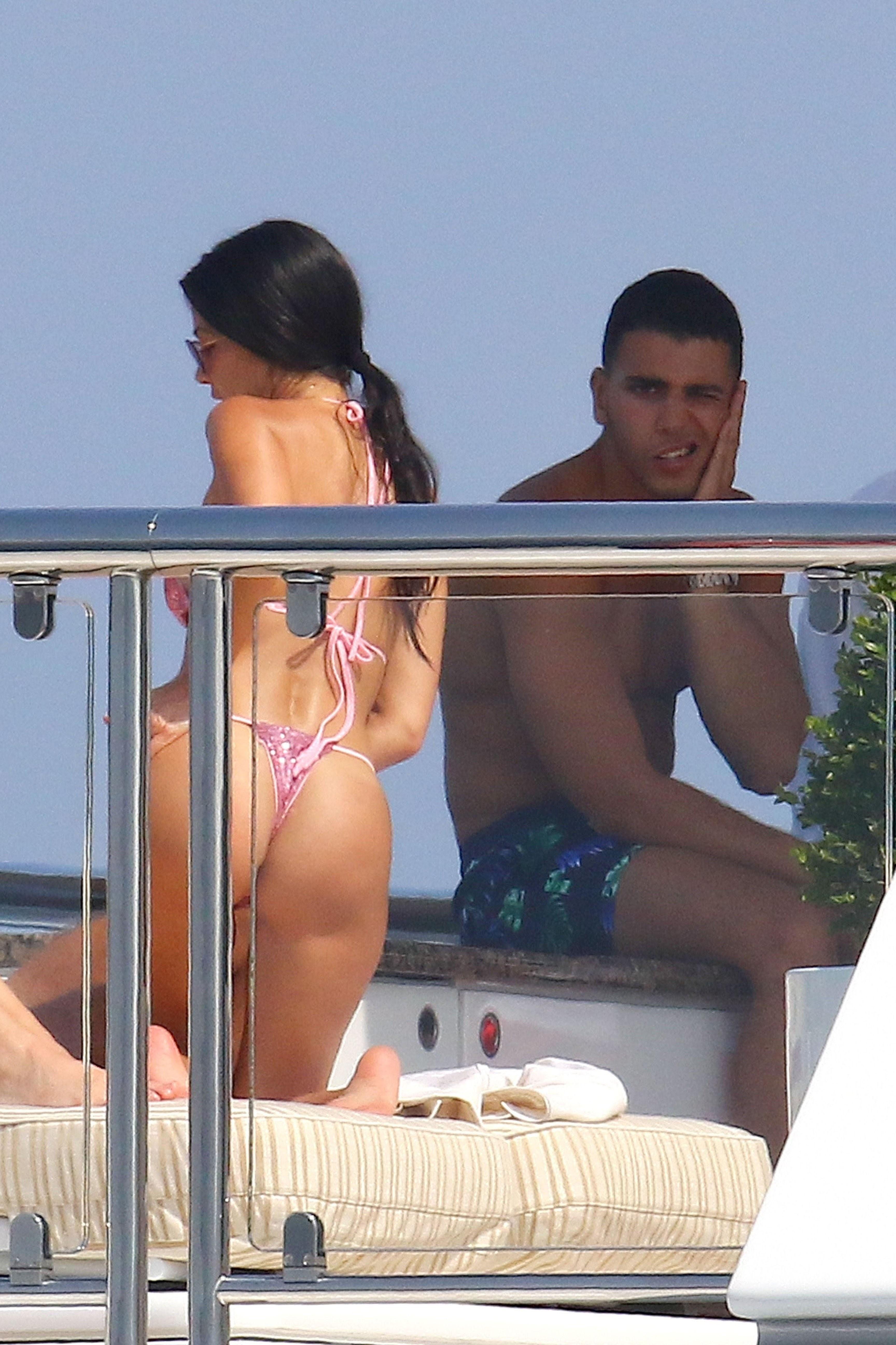 Kourtney Kardashian shows off her sexy bikini body while relaxing on a yacht