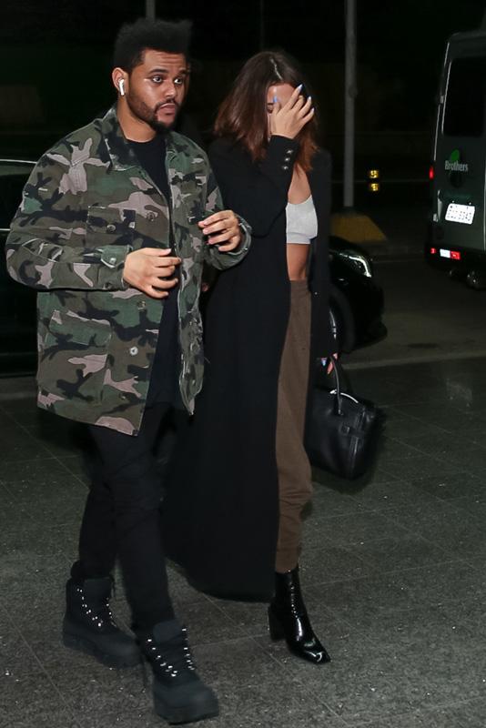 *EXCLUSIVE* The Weeknd and Selena Gomez keep close on their way to a flight after Lollapalooza Brazil