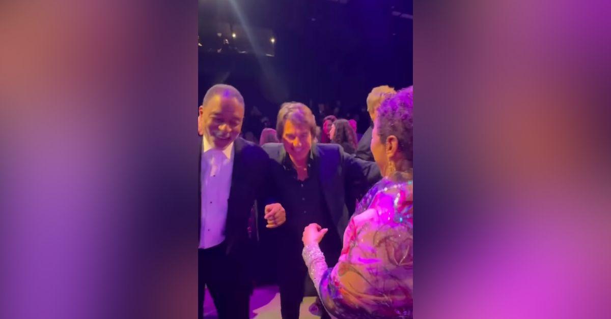 Image of Tom Cruise and Debbie Allen let loose together at a party.