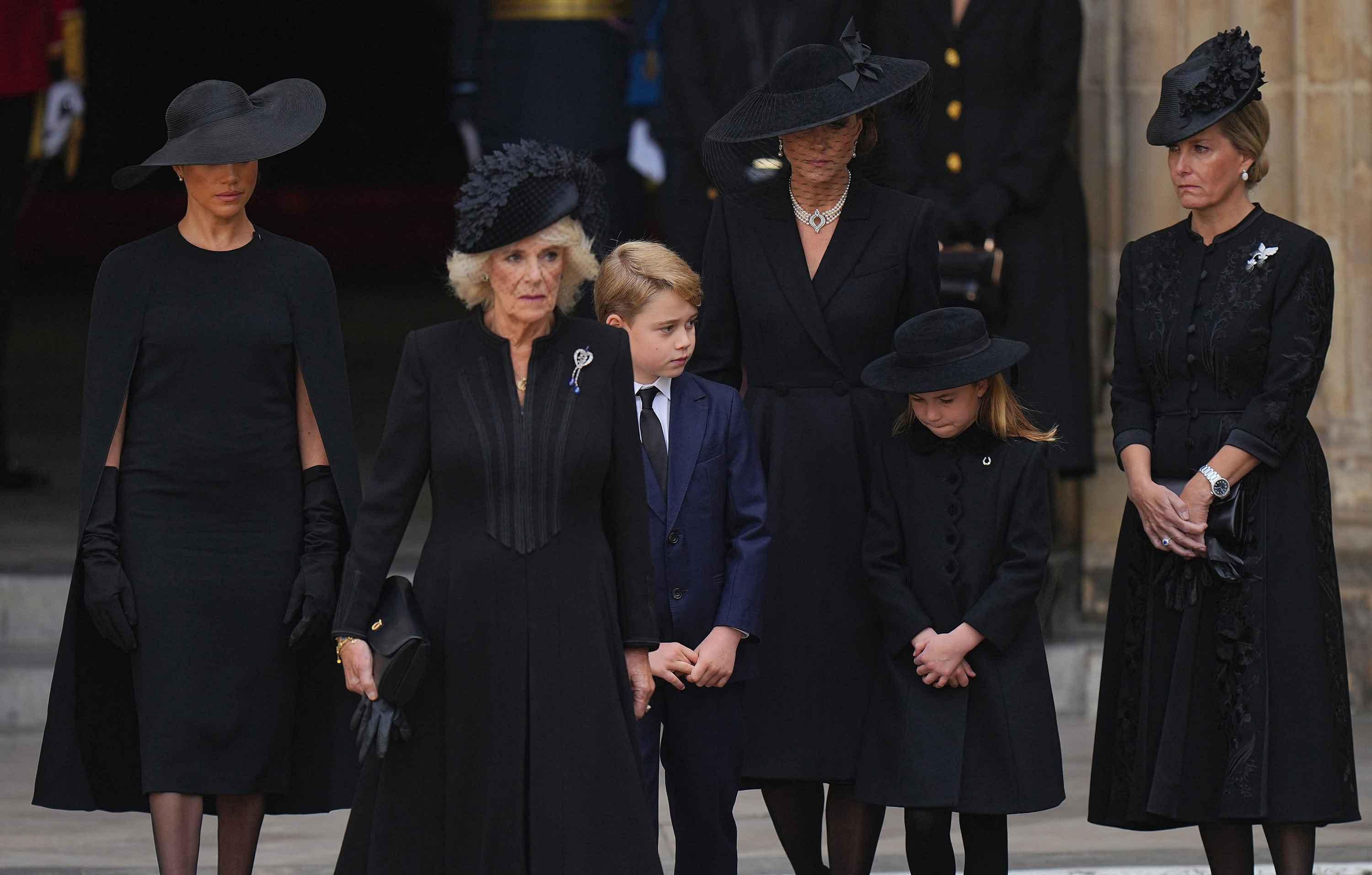 meghan markle standing slightly away from royal family at queens funeral signals a possible emotional distance