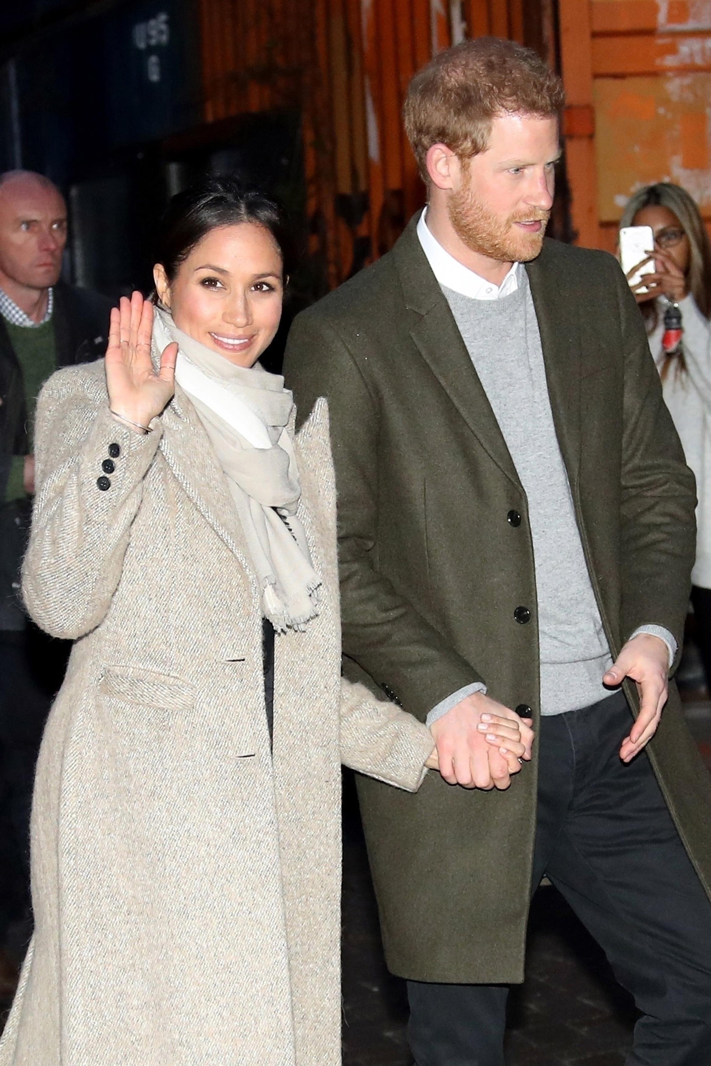 Prince Harry and fiancée Meghan Markle wave to fans leaving Reprezent 107.3FM in Brixton