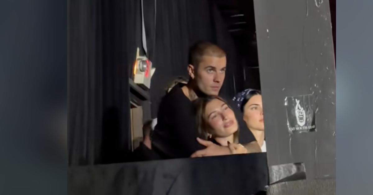 Photo of Justin Bieber — who shaved his head and beard – looked happy as he packed on the PDA with wife Hailey at an October 25 concert.
