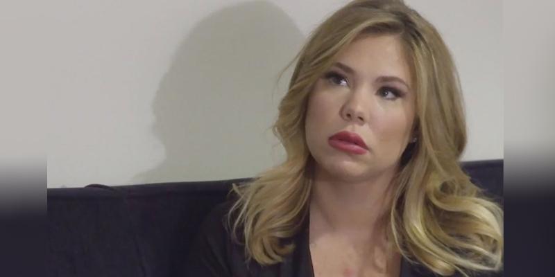 Kailyn Lowry in a black blouse with red puffy lips showing the result of her lip filler procedure