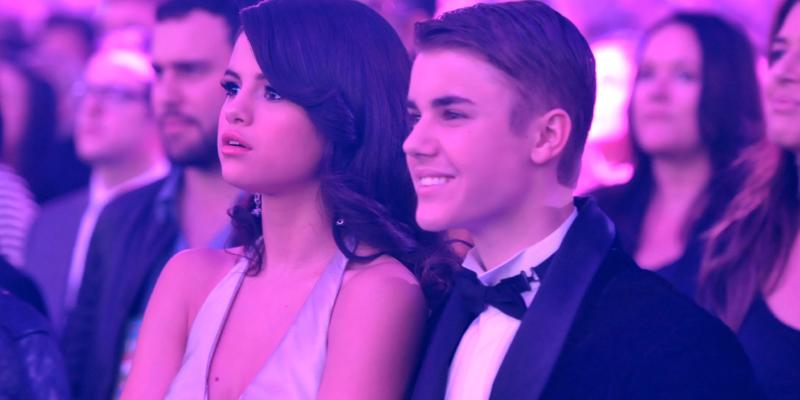 Selena Gomez and Justin Bieber smiling as they attend an awards show together