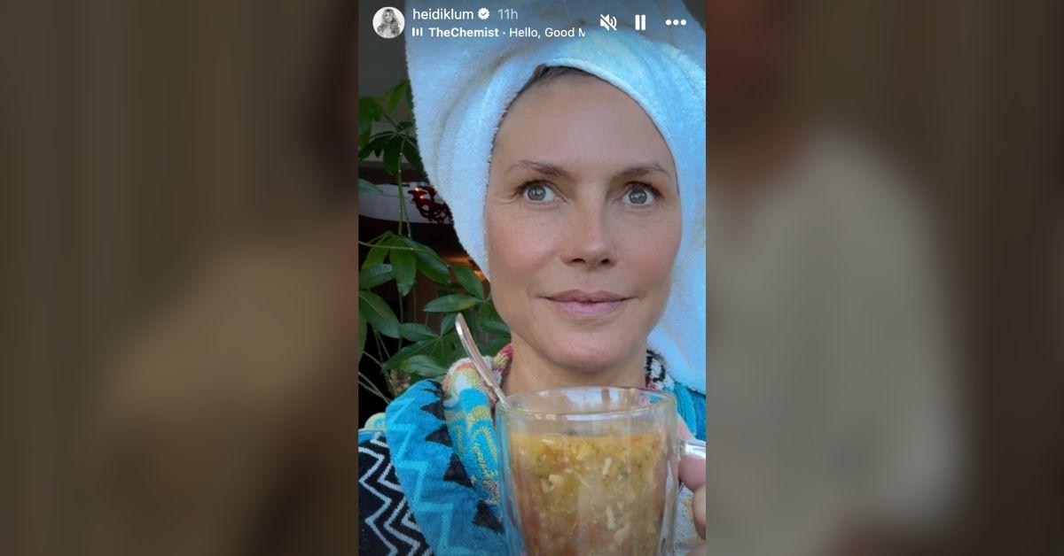 Image of Heidi Klum relaxed with a cup of soup.