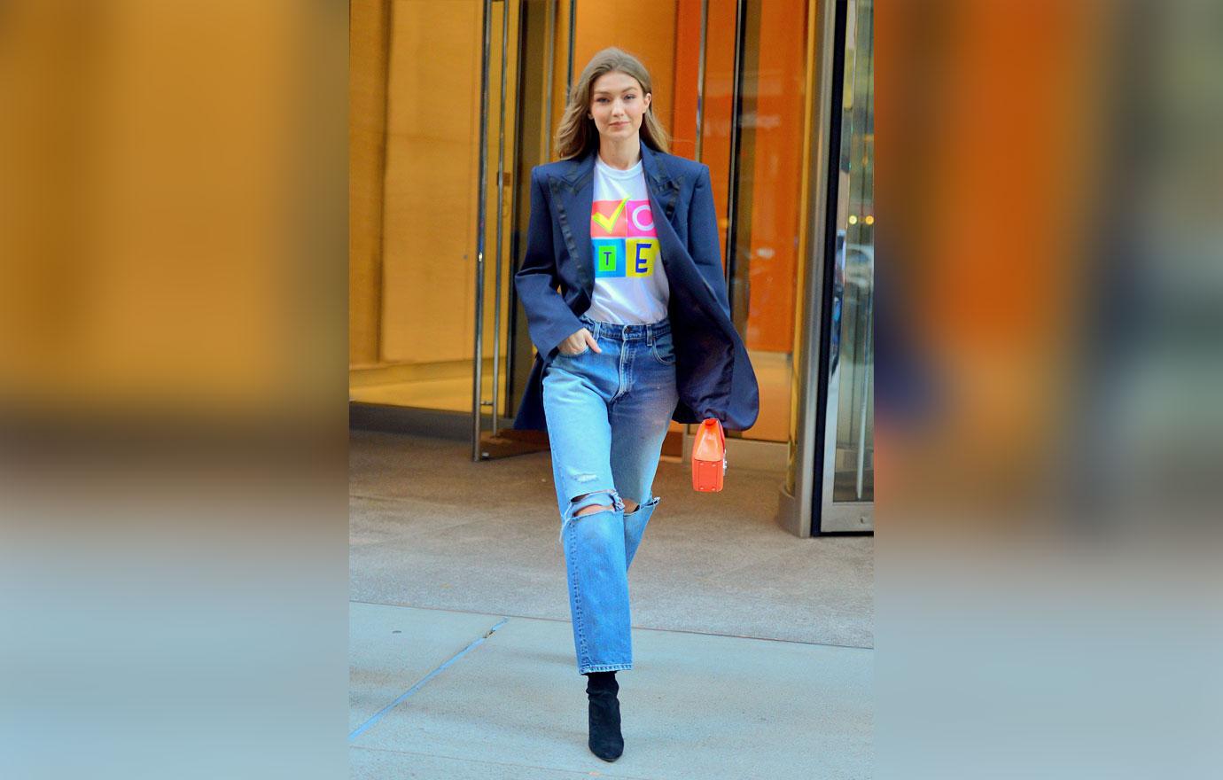 Gigi Hadid is all smiles showing off her VOTE t shirt as she leaves Victoria Secret fashion show fittings in NYC