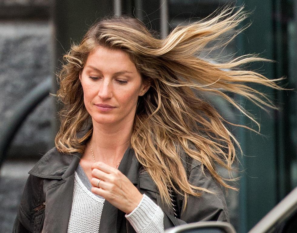 Gisele Bundchen&#8217;s hair blows in the Boston wind as she leaves a restaurant Saturday.