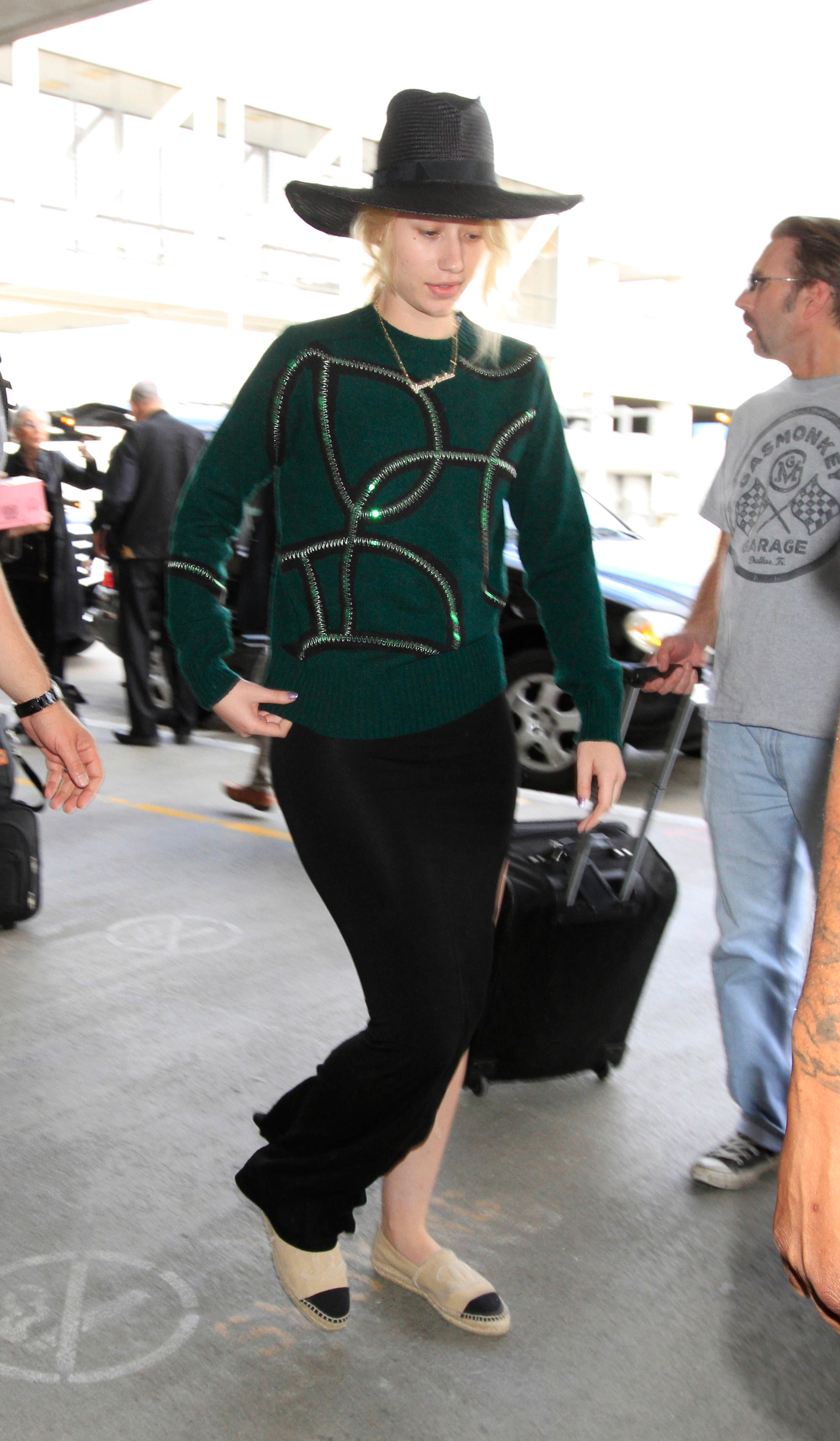 Iggy Azalea looks half asleep as she catches a flight out of Los Angeles