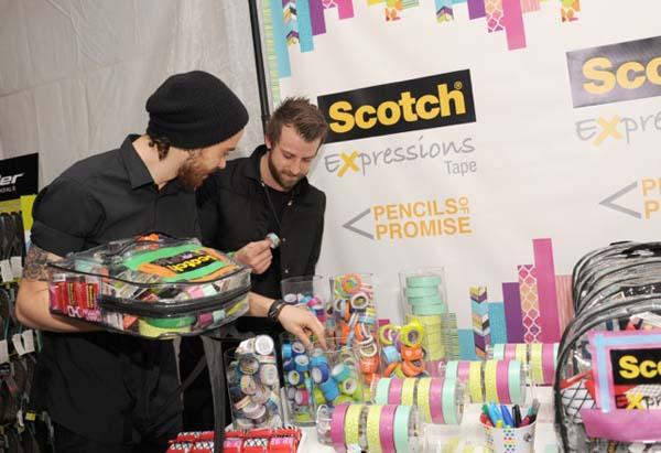 Paramore (Jeremy Davis and Taylor York) signs a Scotch Expressions Tape decorated backpack to benefit Pencils of Promise at the Backstage Creations Celebrity Retreat At Teen Choice 2