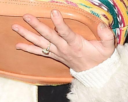 Miley Cyrus wearing a ring on her engagement finger arrives at JFK airport NYC