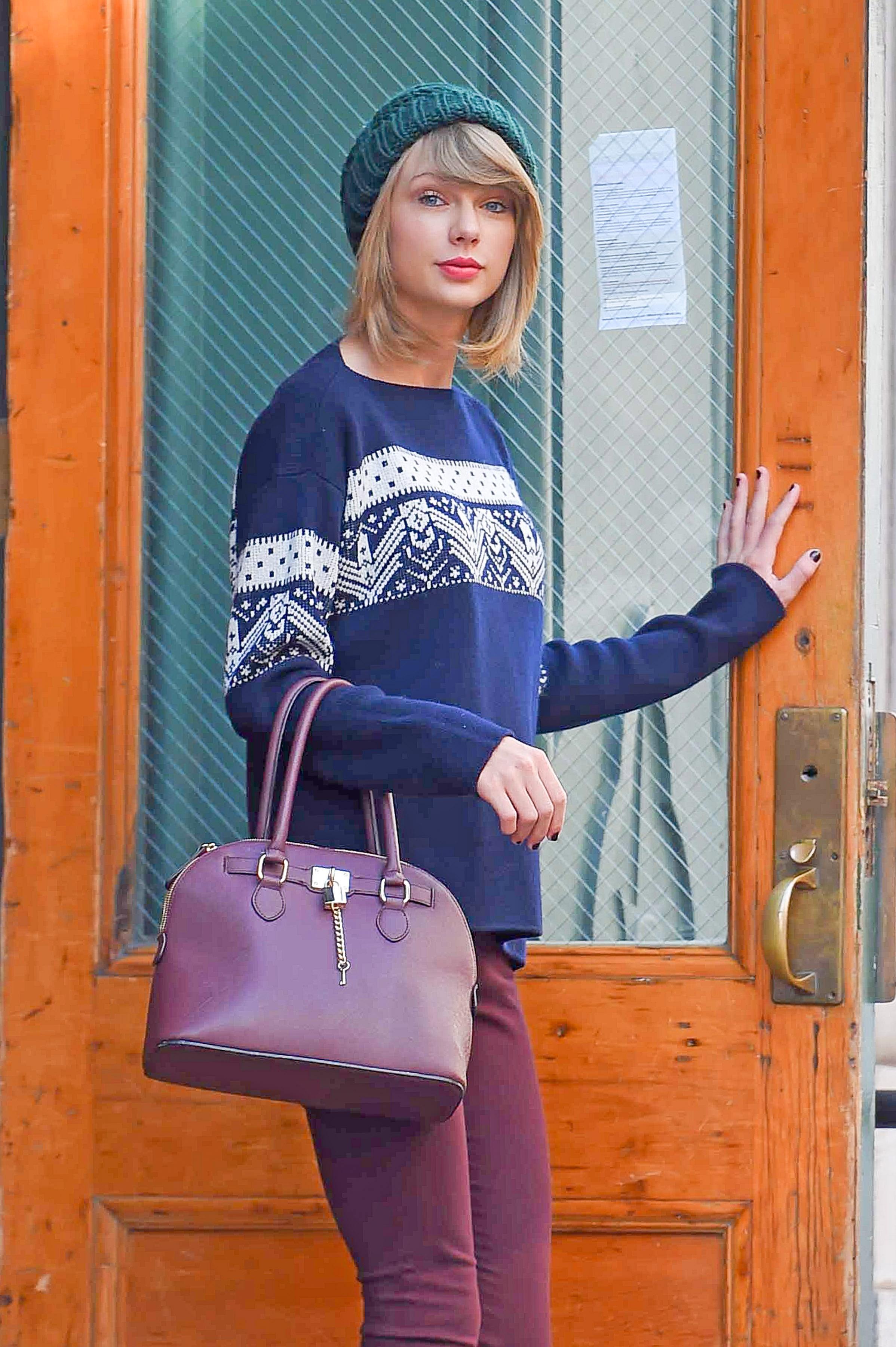 Taylor Swift heads out wearing a beanie and knee high boots in New York City