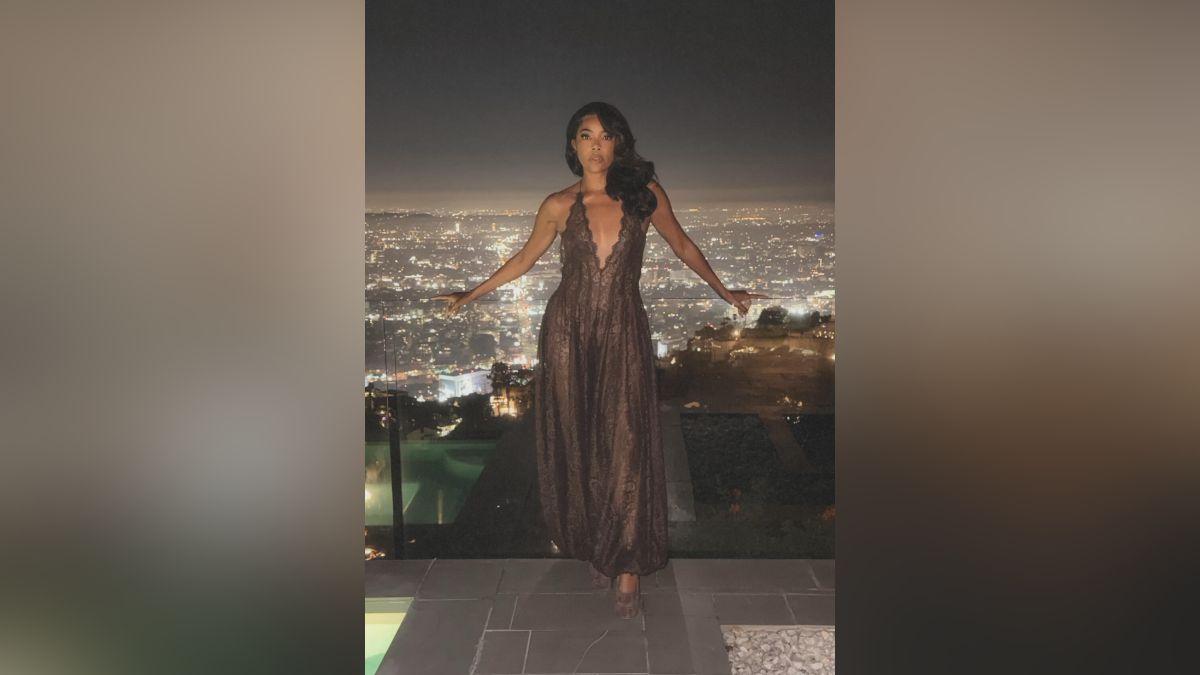 Image of Gabrielle Union posed on a balcony overlooking the skyline.