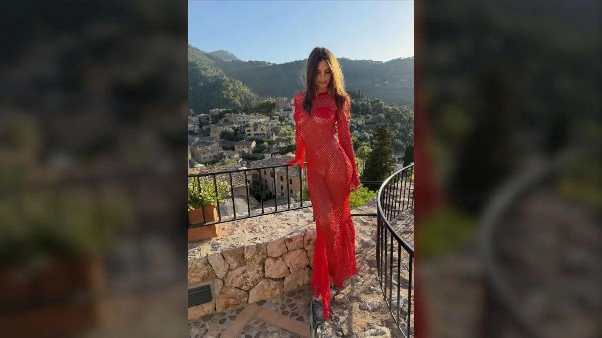 Photo of Emily Ratajkowski posed outdoors while on a luxury overseas vacation. 
