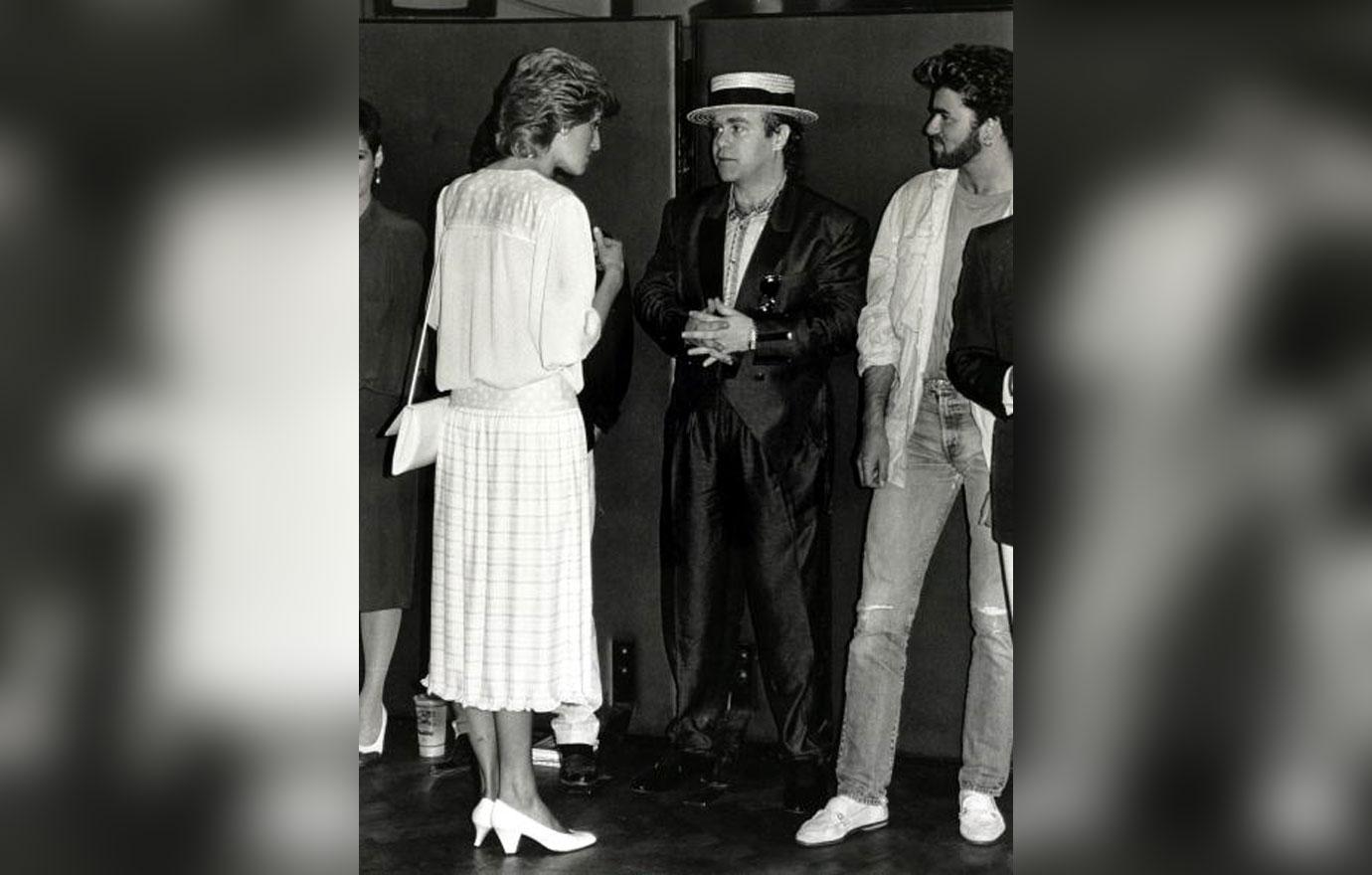 British Royalty. Music. pic: 13th July 1985. Diana, Princess of Wales pictured chatting to musicians Elton John (centre) and George Michael at the &#8220;Feed the World&#8221; Live Aid concert at Wembley.