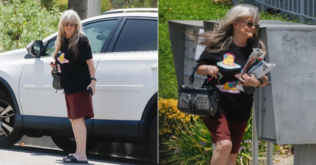 Photo of Susan Olsen looked casual in a black screen t-shirt and shorts.