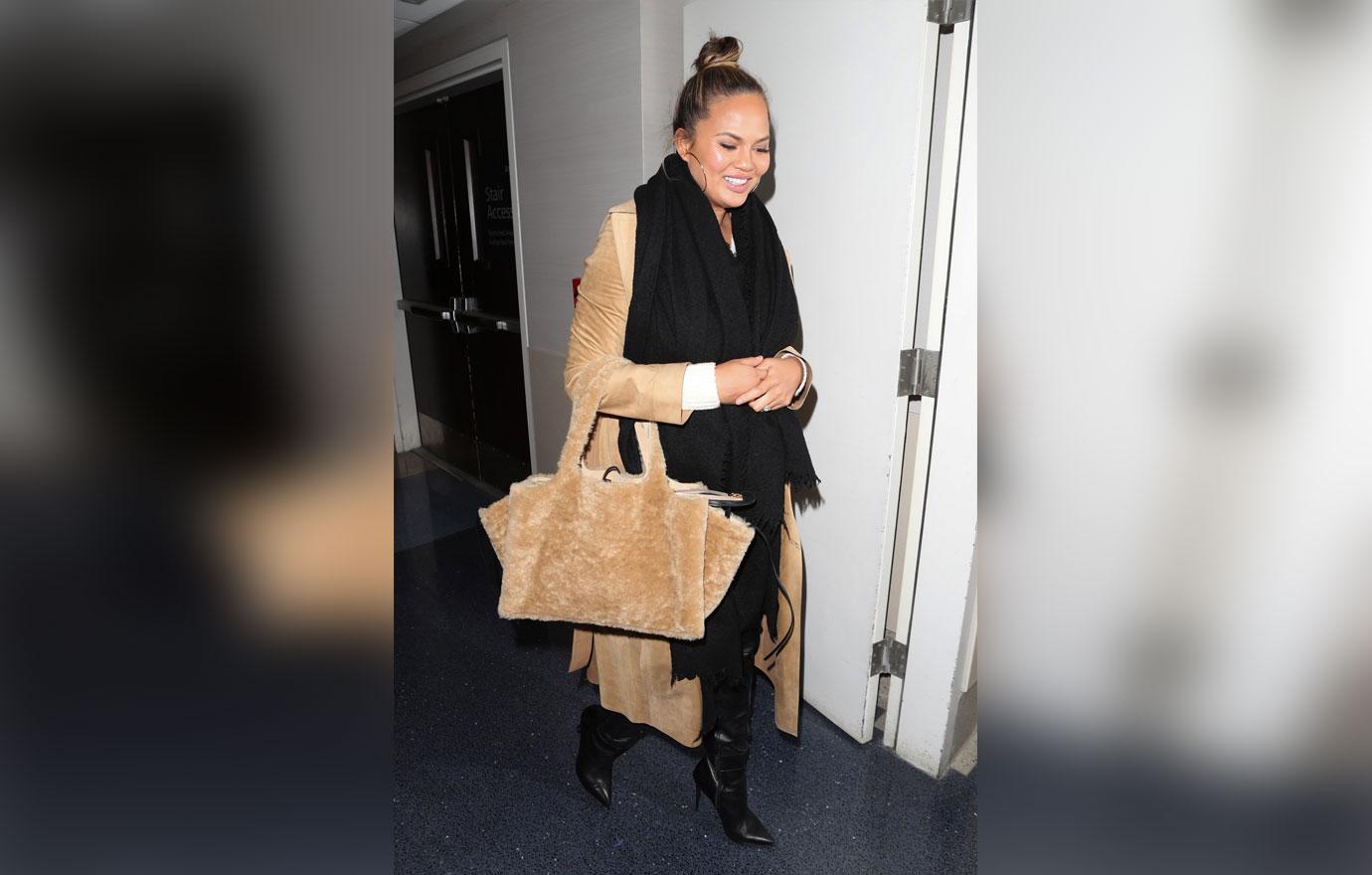 Chrissy Teigen bundles up for a late flight