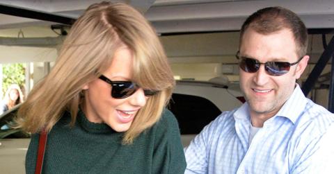 Taylor Swift gets guided by her bodyguard as she walks backwards to her car to avoid the paparazzi while out visiting a friend in West Hollywood, Ca