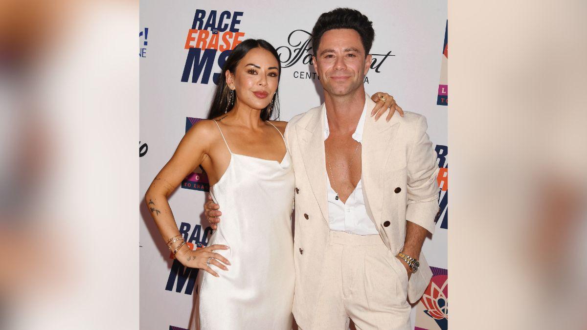 Image of The couple coordinated in matching white outfits.