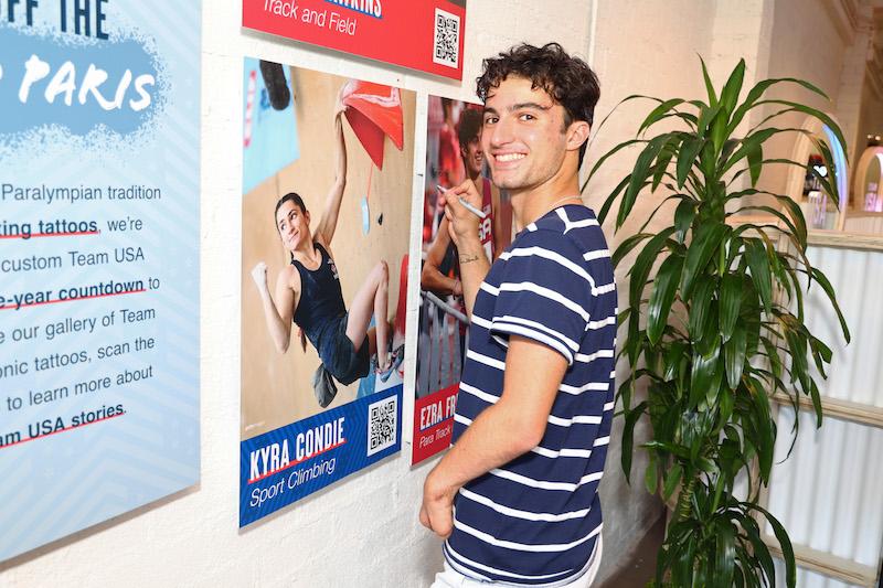 paralympian ezra frech signs the wall at team usa party at ephemeral tattoo in la credit getty images for usopc