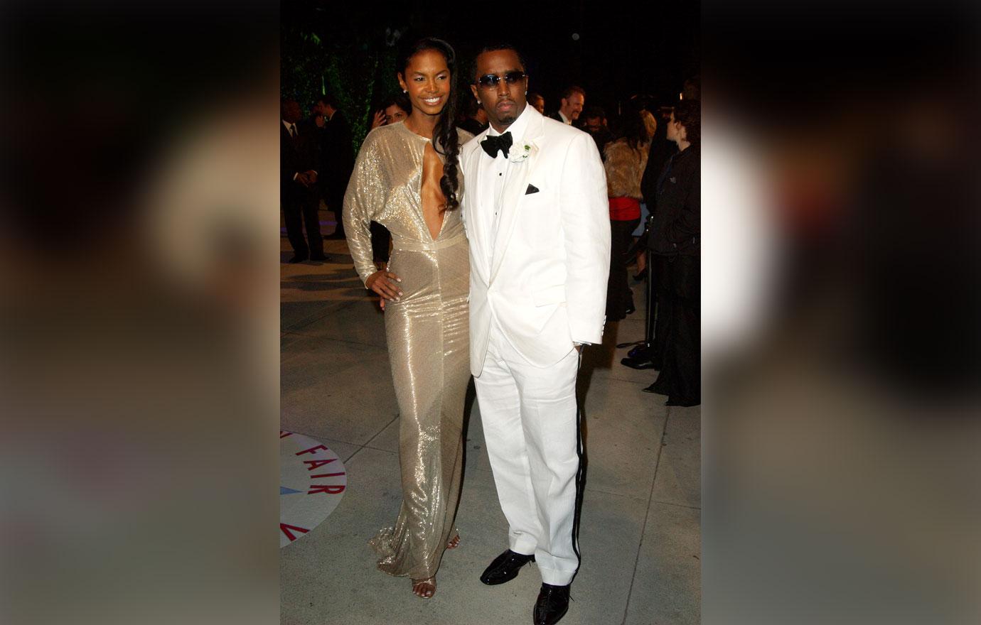 Kim Porter in gold dress with Diddy