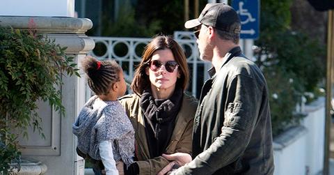 EXCLUSIVE: *** Premium Exclusive Rates Apply*** Sandra Bullock doesn’t look to impressed with boyfriend Bryan Randall as she holds her daughter Laila while they pick up coffee in Studio City, CA