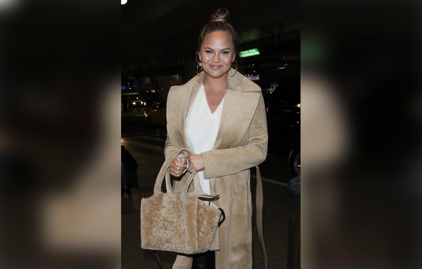 Chrissy Teigen warms up as she dashes to her flight