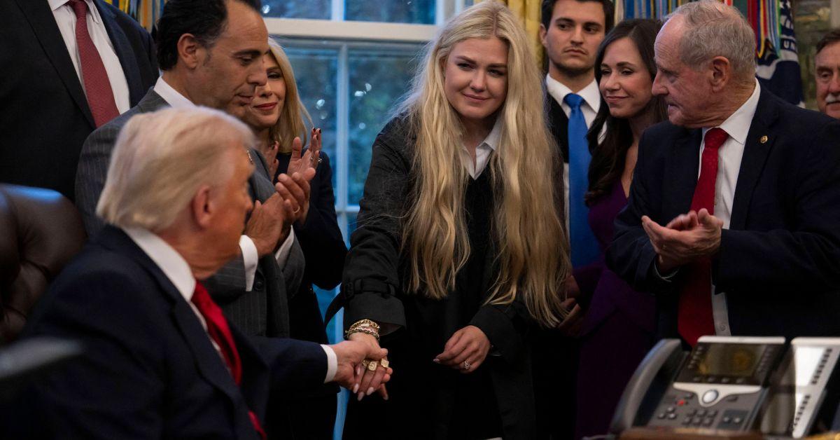 image of The president took Erika Kirk's hand to pull her in for a kiss on the cheek.