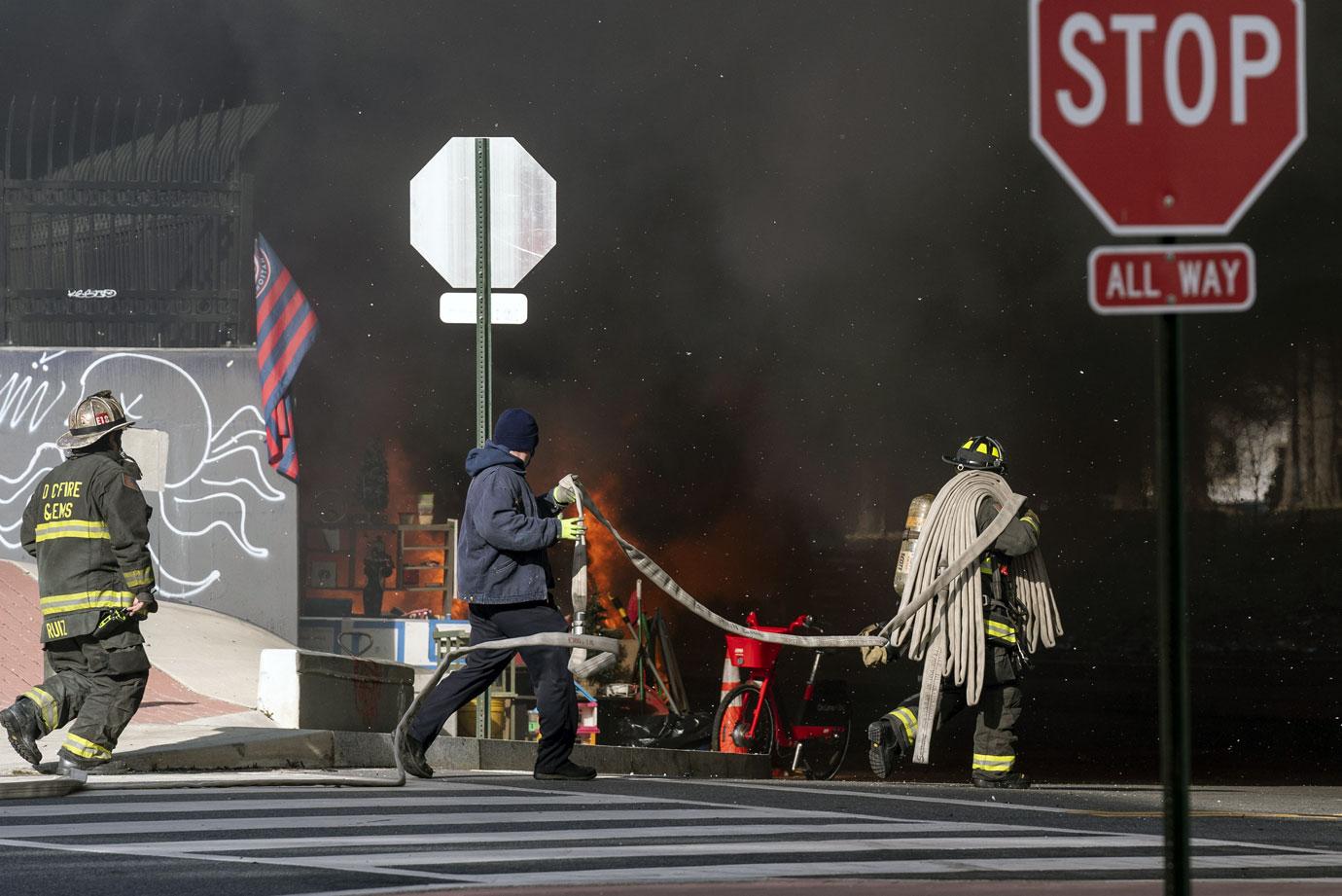 Firefighters respond to a fire at a homeless encampment near the U.S. Capitol in Washington, DC on Monday, January 18, 2021. 