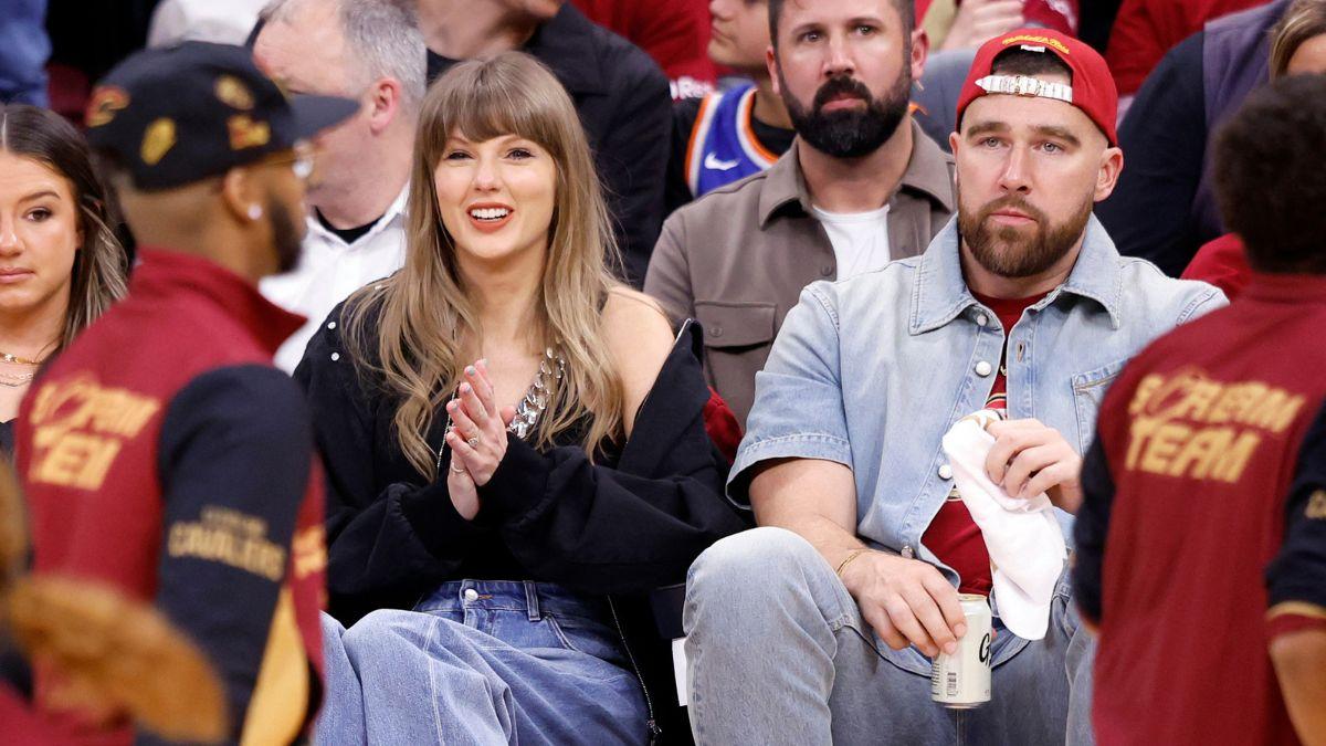 Image of Taylor Swift laughed beside Travis Kelce as the crowd cheered.