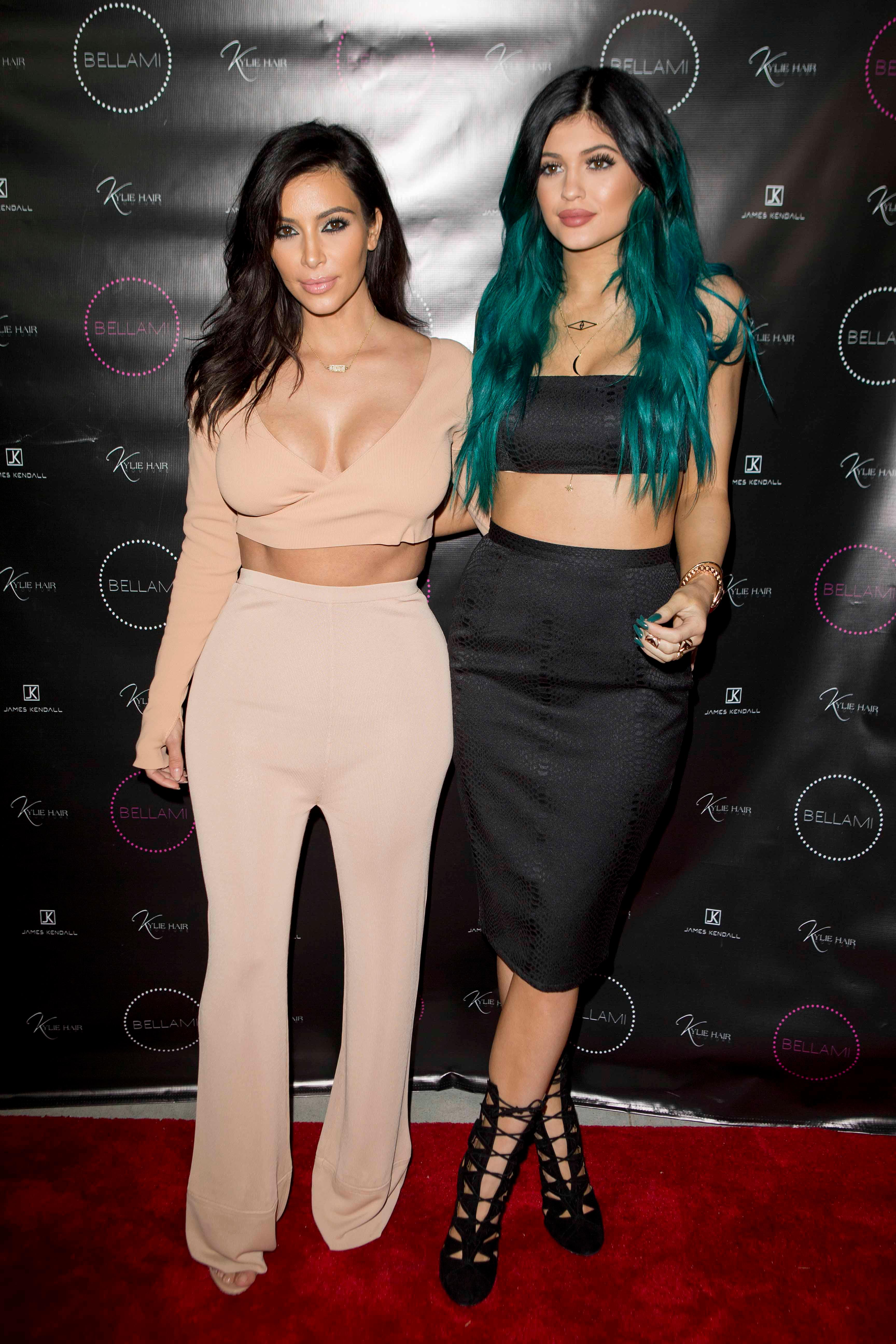 Kylie Jenner poses happily with her sisters on her big hair line extension night launch party LA