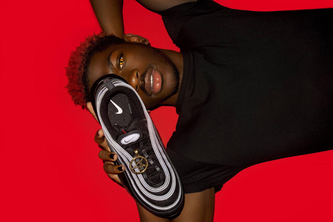 lil nas x poses with his custom satan shoes