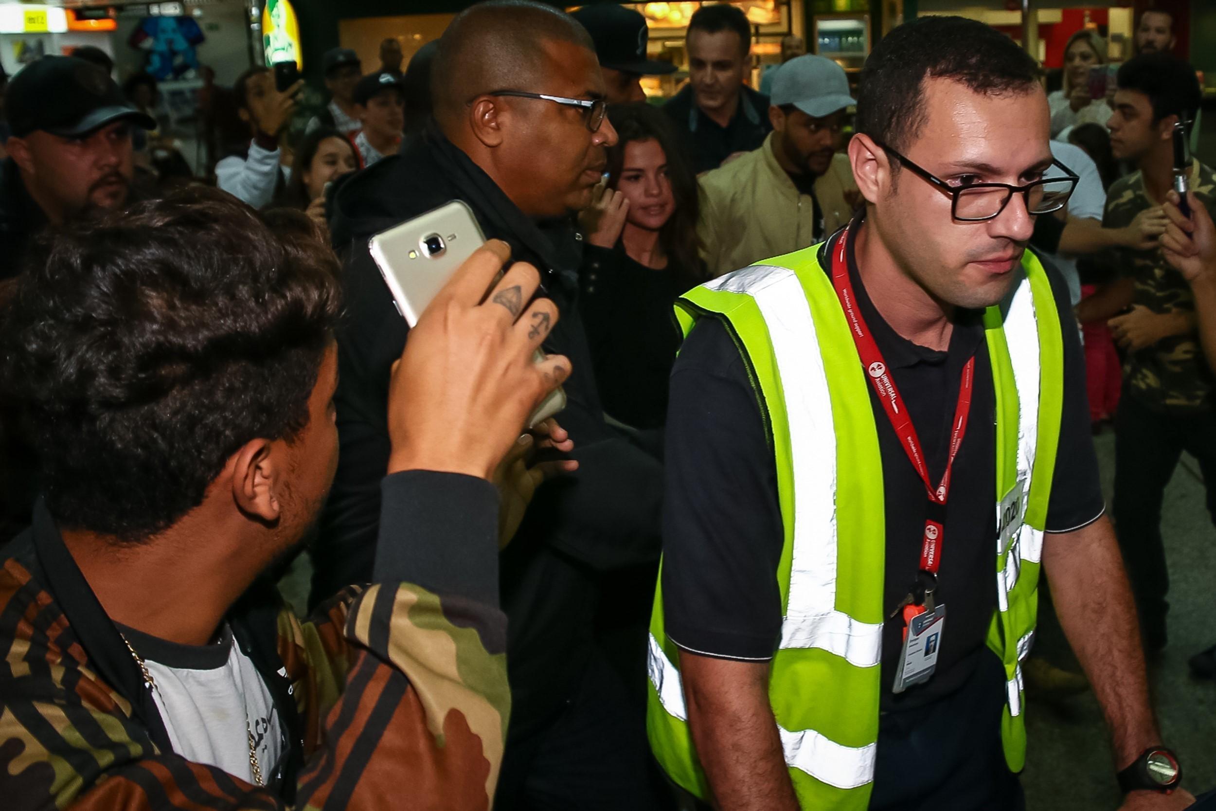 *EXCLUSIVE* Selena Gomez and The Weeknd struggle to make their way through crowds at Guarulhos airport