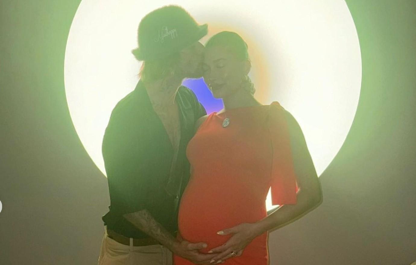 justin bieber kisses cradles hailey growing bump await baby photos