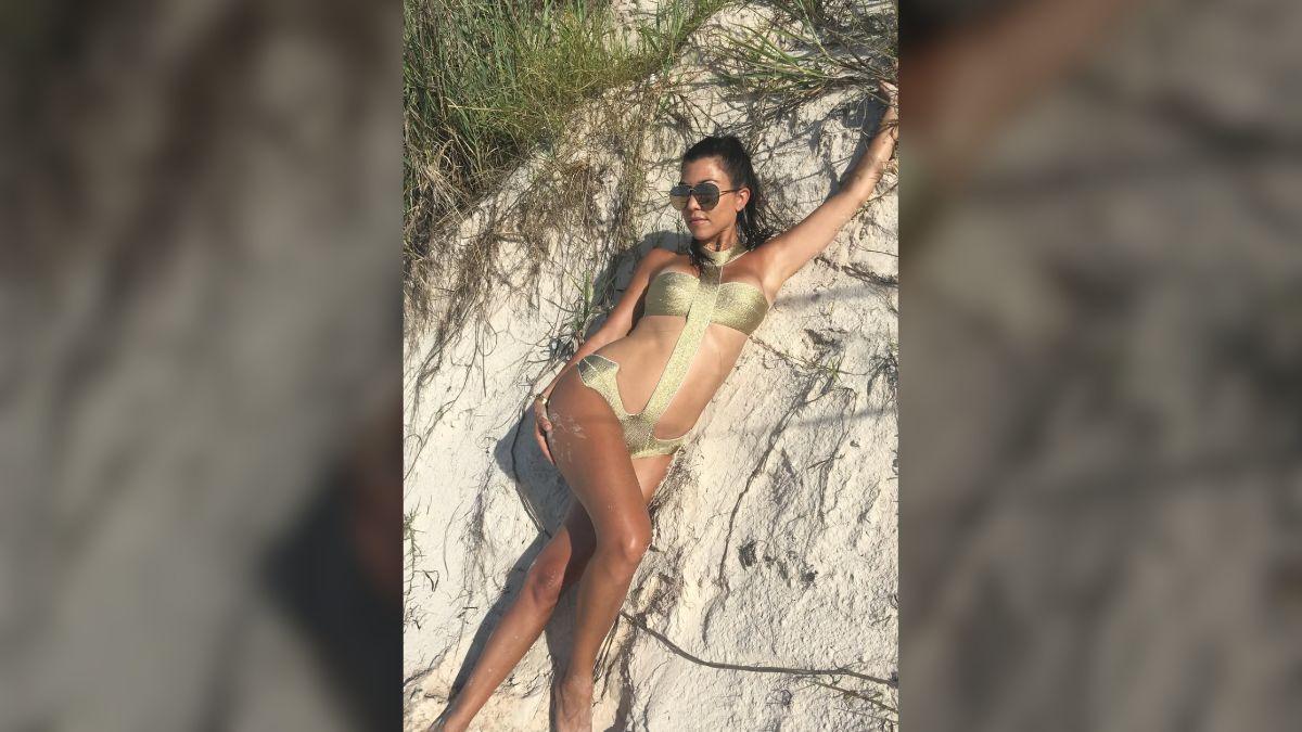 Image of Kourtney Kardashian looked glamorous in a gold swimsuit.