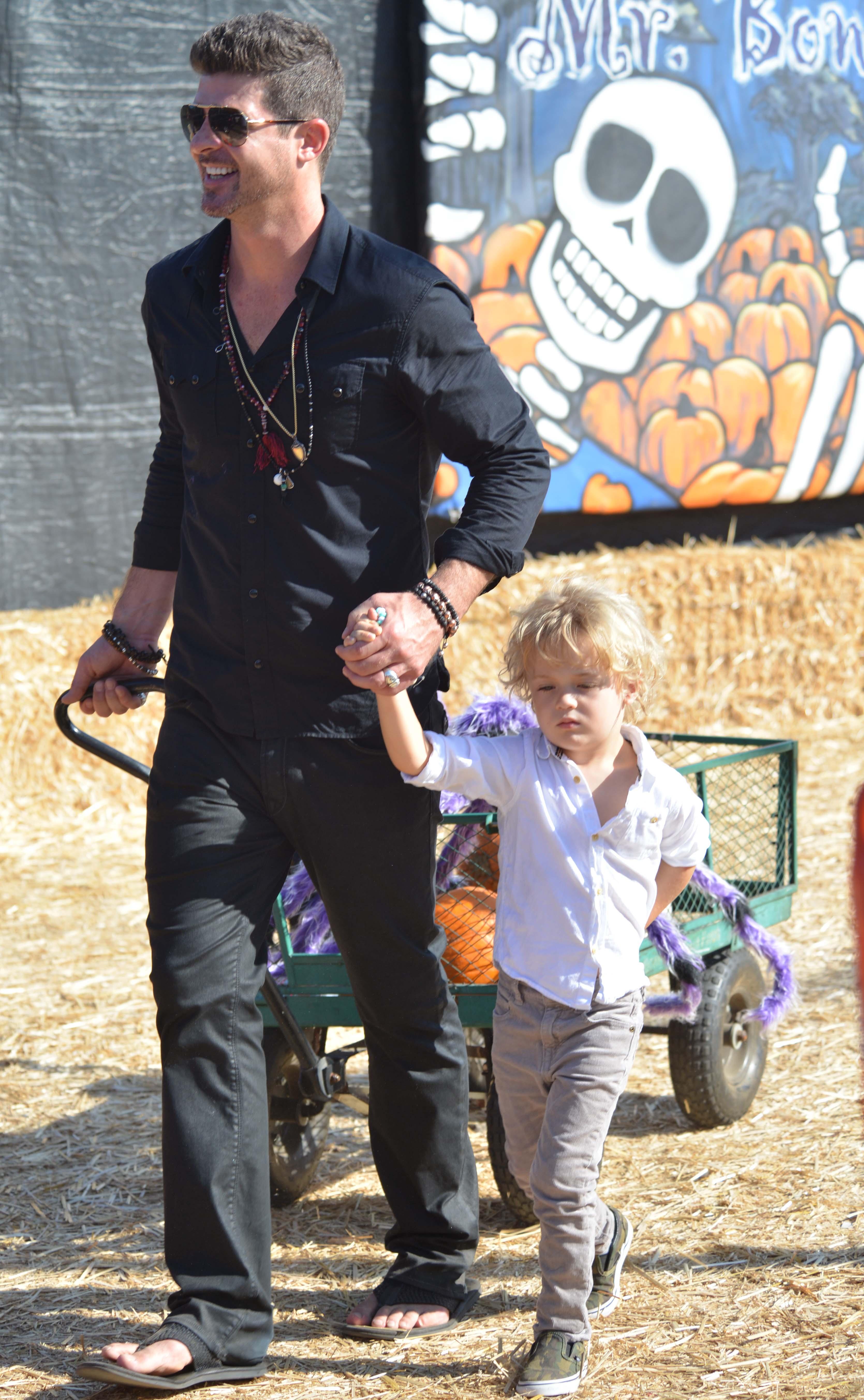 Singer Robin Thicke is spotted loading up on pumpkins at Mr. Bones Pumpkin Patch in West Hollywood, CA along with his young son Julian