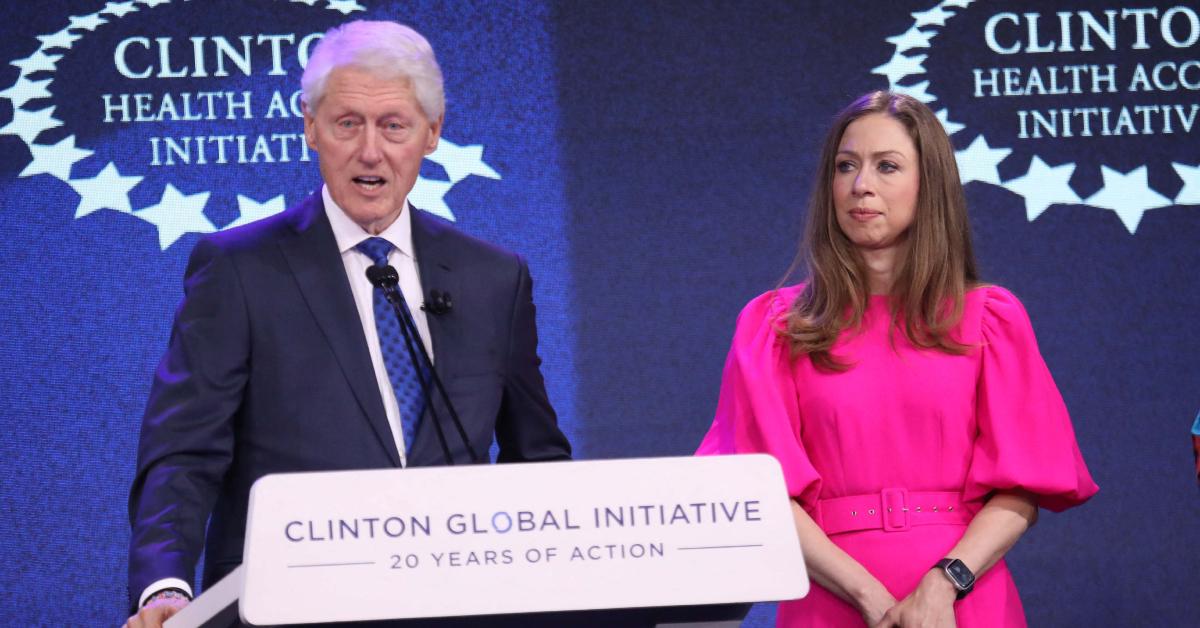 Image of Bill Clinton was photographed hugging his daughter after she finished her race.