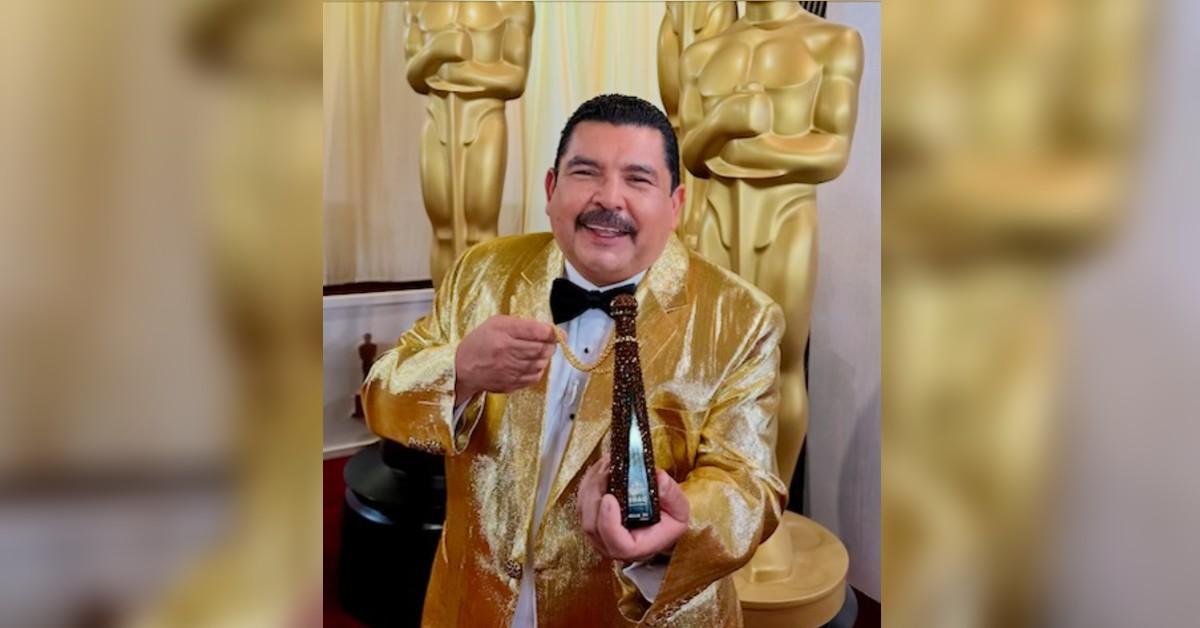 guillermo rodriguez showing off his new bling on the red carpet a custom bedazzled mini bottle of tequila don julio