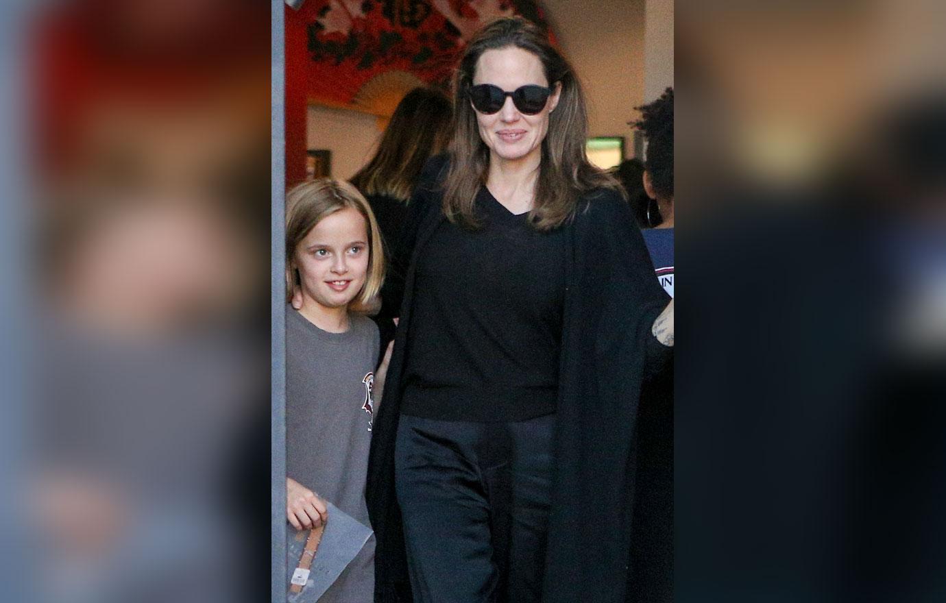 Angelina Jolie is every inch the proud parent as she escorts daughter Vivienne to her karate graduation.