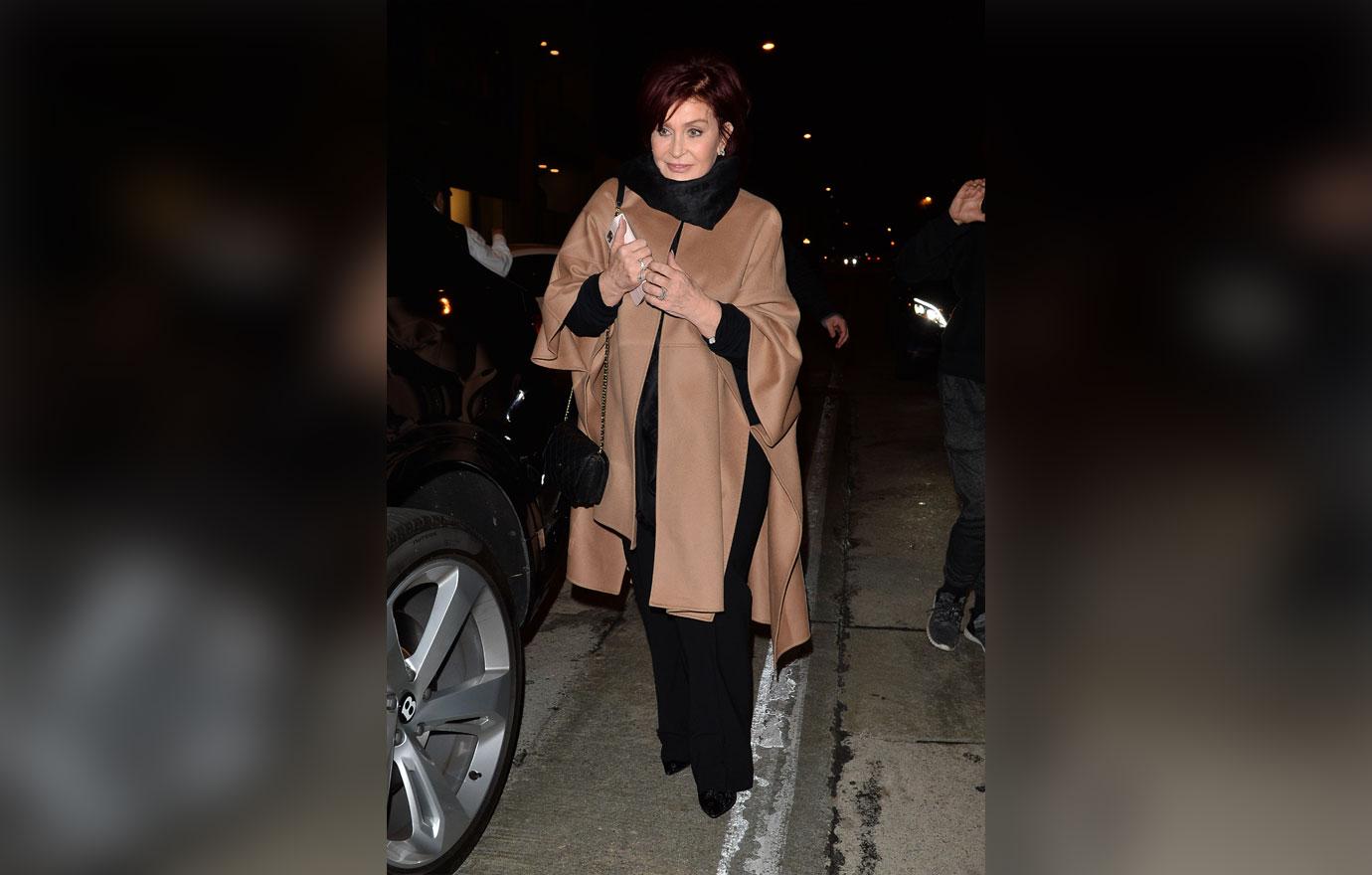 sharon osbourne walking in brown coat