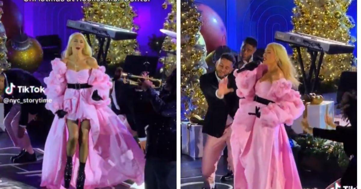 image of The singer wore a dramatic pink gown with ruffled sleeves and a flowing train.