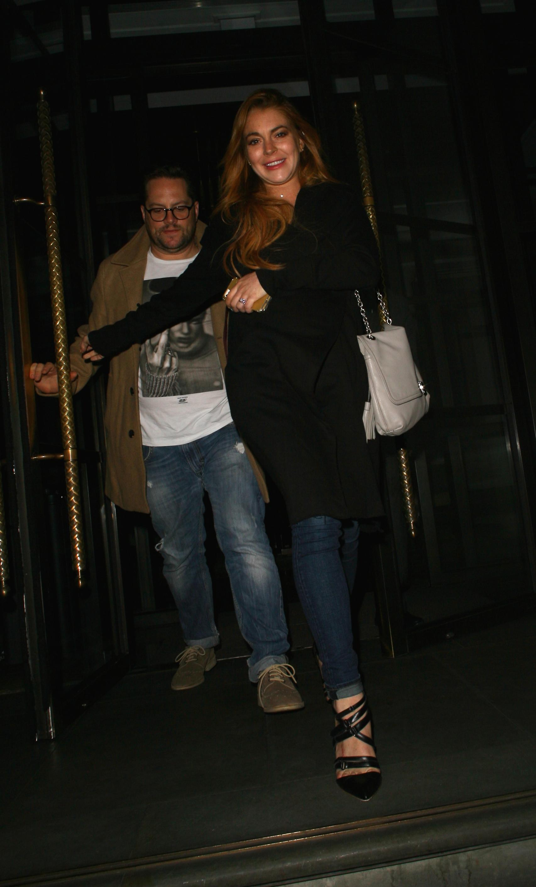 Lindsay Lohan is all smiles as she leaves the Corinthia Hotel in London, England at 1 am on September 25, 2014, after spending a few hours in there after her opening night of &#8216;Speed The Plow&#8217;