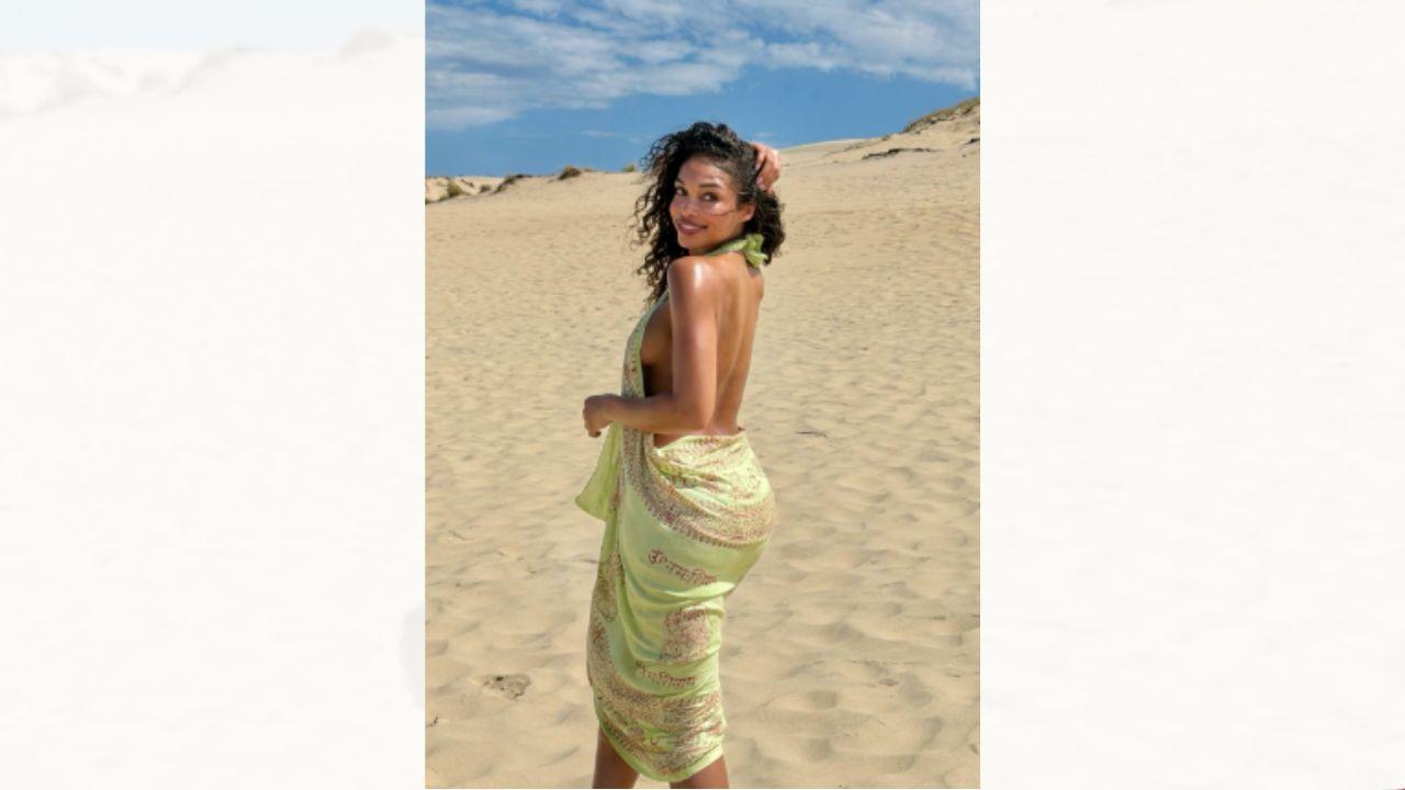 Image of Lori Harvey covered up her assets with a summery sarong. 