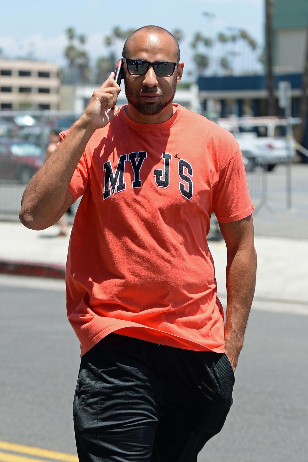 EXCLUSIVE: Hank Baskett heads into a Hollywood office building with his hand in his pocket, hiding his wedding ring