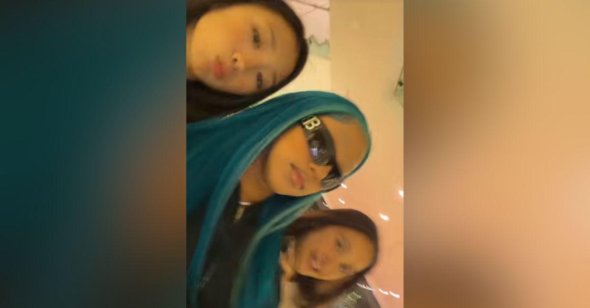 image of The teenager smiled and flashed a peace sign at paparazzi outside the restaurant.